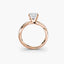 Rose gold ring with a diamond on a white background