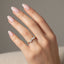 Marquise pear and round diamond stacking ring on the womens hand