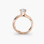 Rose gold ring with a diamond on a white background