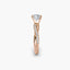 Rose gold ring with a diamond on a white background