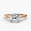 Rose gold solitaire ring with a large cushion-cut diamond on a white background