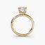 Front-facing view of the Solaris cushion-cut diamond solitaire engagement ring in 14k yellow gold, showcasing the eight-prong tulip basket setting and plain rounded band against a light gray background.