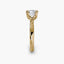 Side profile of the Solaris cushion-cut diamond solitaire engagement ring in 14k yellow gold, showing the tapered polished shank rising to an eight-prong floral-style crown against a light gray background.