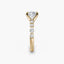 Gold ring with a cushion-shaped diamond and smaller round diamonds on a white background