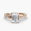 Rose gold ring with a large emerald-cut diamond and smaller diamonds on the twisted band against a white background