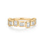 Gold ring with emerald-cut diamonds on a white background