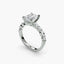 Diamond ring with a central emerald-cut diamond and smaller diamonds on a white background