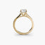 Gold ring with a diamond on a white background
