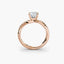 Rose gold ring with a diamond on a white background
