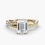 Gold ring with a large emerald-cut diamond and smaller diamonds on the twisted band against a white background