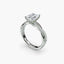 Diamond ring with a central emerald gemstone on a white background