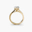 Gold ring with a diamond on a white background