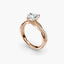 Rose gold ring with a diamond on a white background