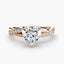 Rose gold ring with a heart-shaped diamond and twisted pave band on a white background