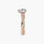 Rose gold ring with a heart-shaped diamond on a white background