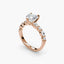 Rose gold ring with a large diamond and smaller diamonds on a white background