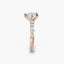 Rose gold ring with a center diamond and smaller round diamonds on a white background