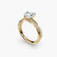 Gold ring with a heart shaped diamond and twisted pave on a white background