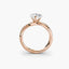 Rose gold ring with a diamond on a white background