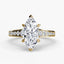 Gold ring with a marquise-shaped diamond on a white background