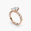 Rose gold ring with a marquise-shaped diamond on a white background