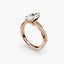 Rose gold ring with a heart-shaped diamond on a white background