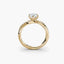Gold ring with a diamond on a white background