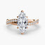 Rose gold ring with a marquise-shaped diamond twisted pave band on a white background