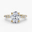 Gold ring with a large oval cut diamond and smaller marquise round diamonds on the sides against a white background