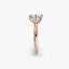 Profile view of The Alaria showing oval diamond secured with double prong setting rose gold