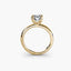 Side view of The Alaria showing oval diamond secured with double prong setting yellow gold