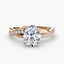 Rose gold ring with a oval center diamond and twisted pave shank on a white background