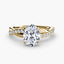 Gold ring with a large oval diamond and smaller diamonds on the twisted band against a white background
