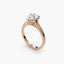 Rose gold ring with a pear-shaped diamond on a white background