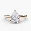 Rose gold ring with a pear-shaped diamond on a white background