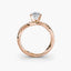 Rose gold ring with a diamond on a white background