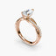 Rose gold ring with a diamond on a white background