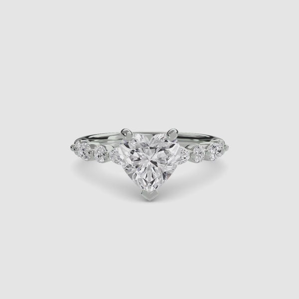 Heart-shaped diamond ring on a white background