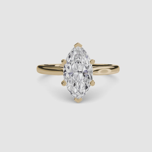 Solitaire gold ring with a marquise-shaped diamond 