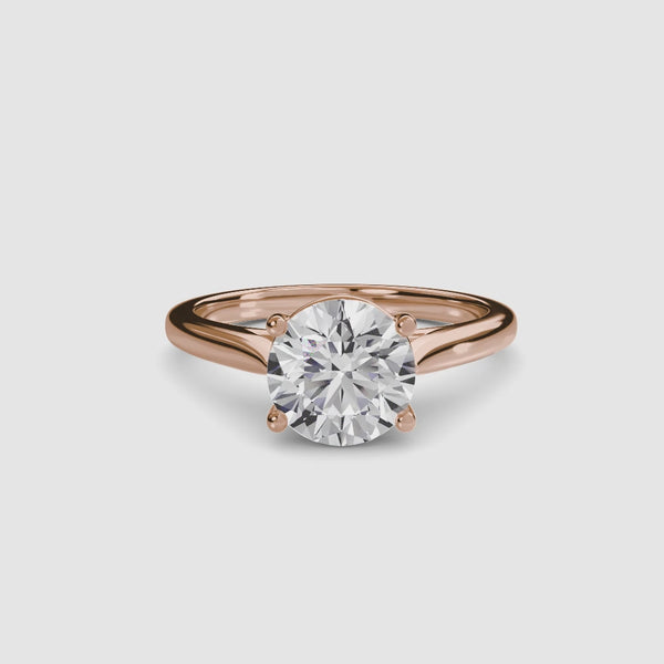 Rose Gold solitaire ring with a round diamond brilliant cut on a white background