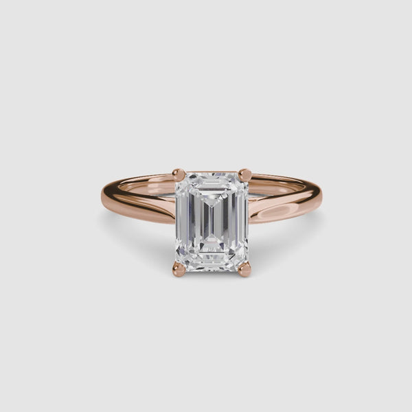 Rose gold solitaire ring with a emerald cut diamond