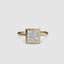 Bezel solitaire gold ring with a princess-cut diamond