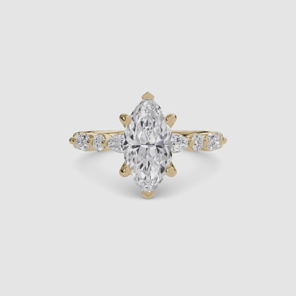 Gold ring with a marquise-cut diamond on the center and side stones marquise round on a white background