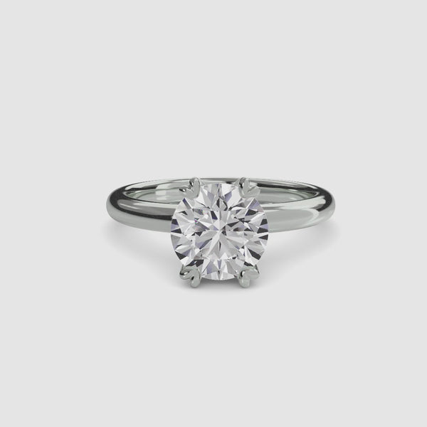 360-degree rotation view The Caelis round brilliant cut diamond solitaire engagement ring with double prong setting in white gold