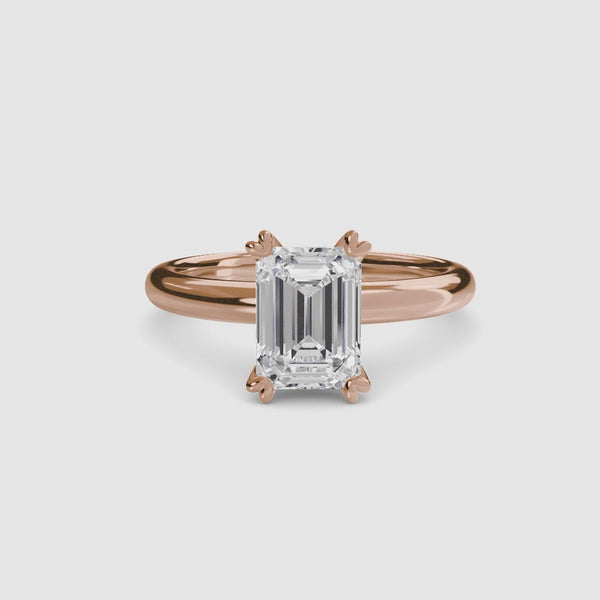 360-degree rotation view the Sylvene emerald cut diamond double prong solitaire engagement ring in rose gold