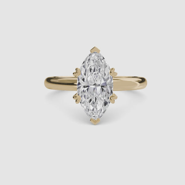 360-degree rotation view the Caelora marquise cut diamond double prong solitaire engagement ring in yellow gold
