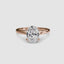 Rose gold solitaire ring with a large oval-cut diamond on a white background
