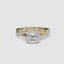 Gold ring with a large Asscher diamond and smaller diamonds on the twisted band against a white background