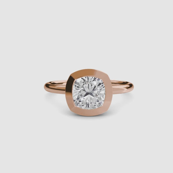 Cushion cur bezel set ring in rose gold solitaire setting