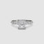 White gold ring with a central radiant cut diamond and marquise and round side stones on the band on a white background